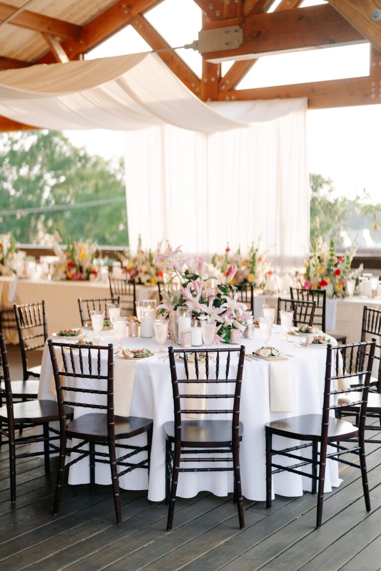 Round tables under draped fabric on the 128 South rooftop