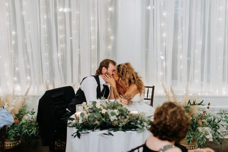 Couple at the sweetheart table in the 128 South hall