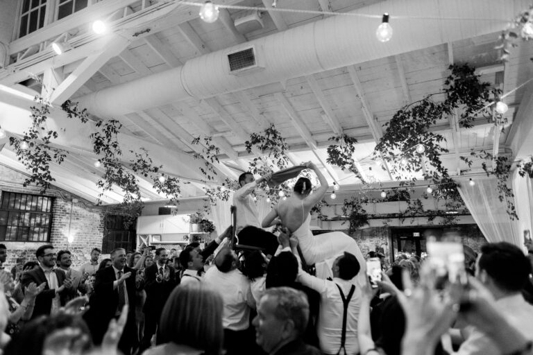Guests lifting the couple on the dance floor at Bakery 105