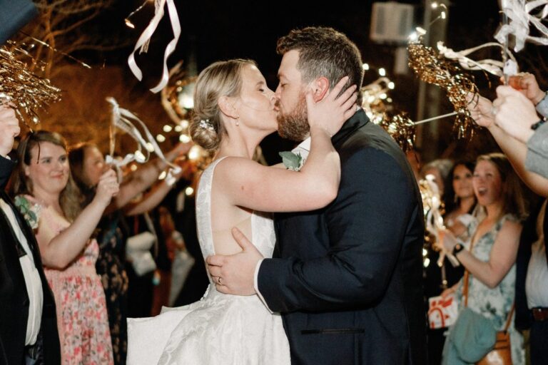 Couple kissing during a sparkler send-off