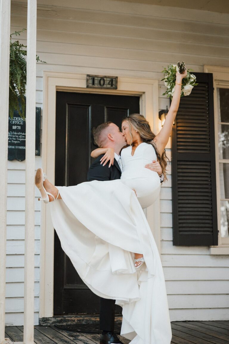 Couple kissing at The Cottage front door