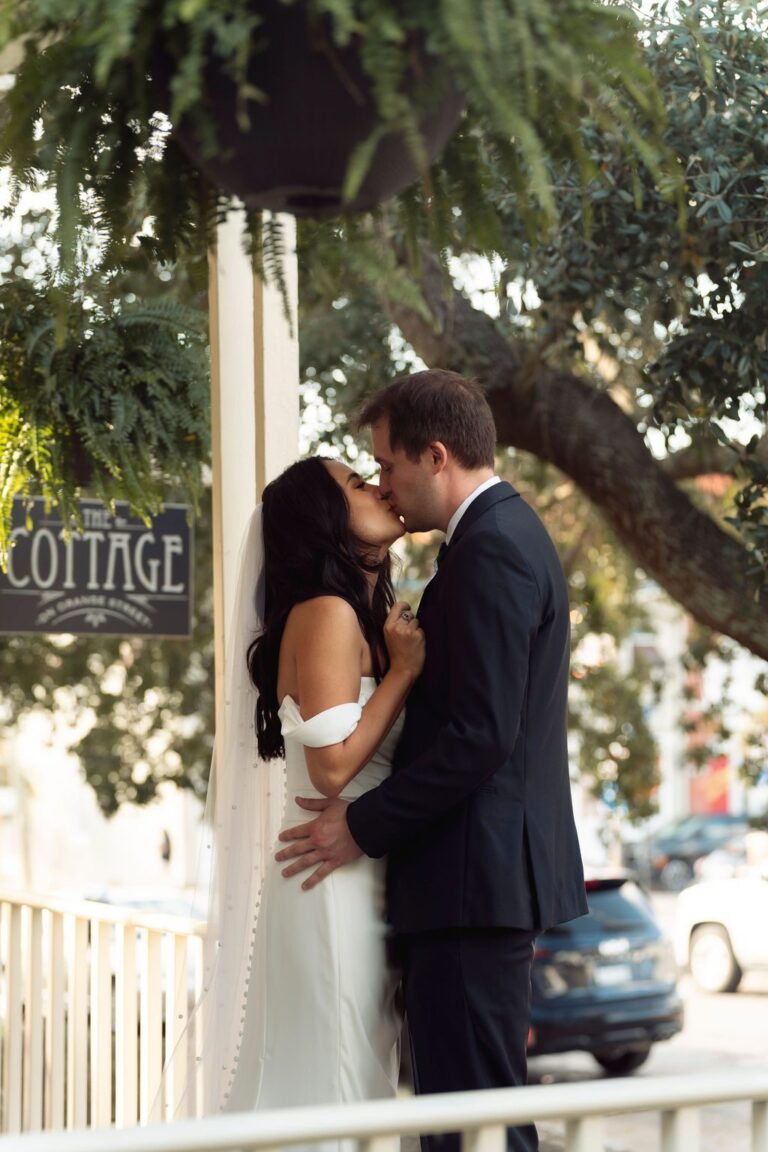 Couple kissing beneath The Cottage sign