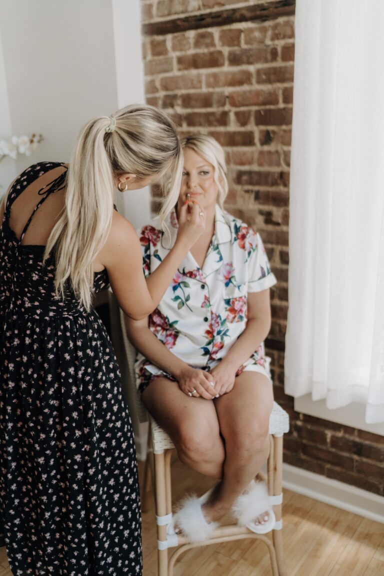 Mother helping the bride into her gown in The Loft