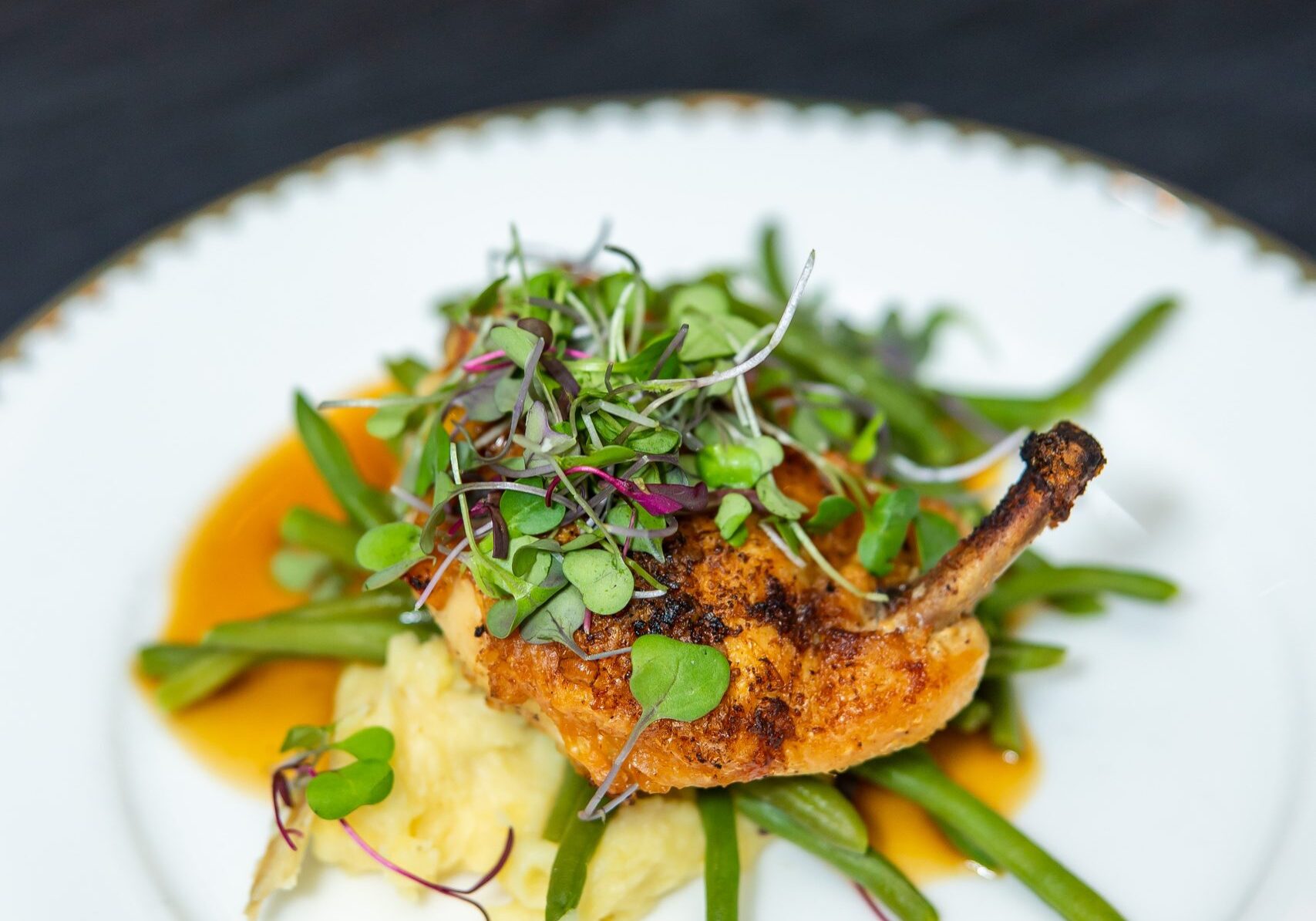 Plated chicken entrée by 128 South Catering